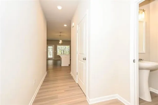 a view of a hallway with wooden floor