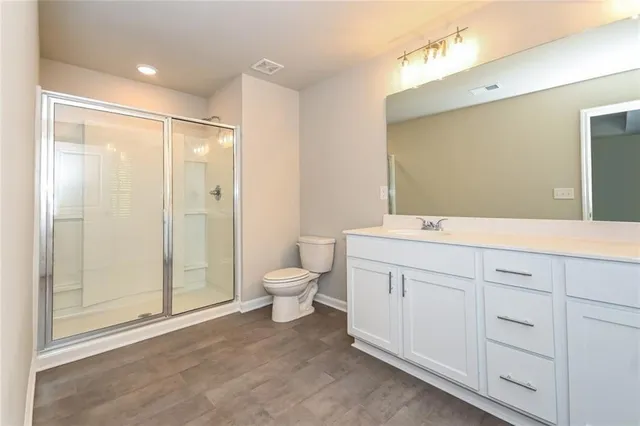 a bathroom with a double vanity sink mirror and toilet