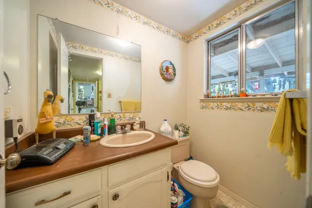 a bathroom with a toilet sink and mirror