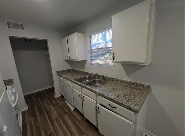 a kitchen with granite countertop a stove and a sink