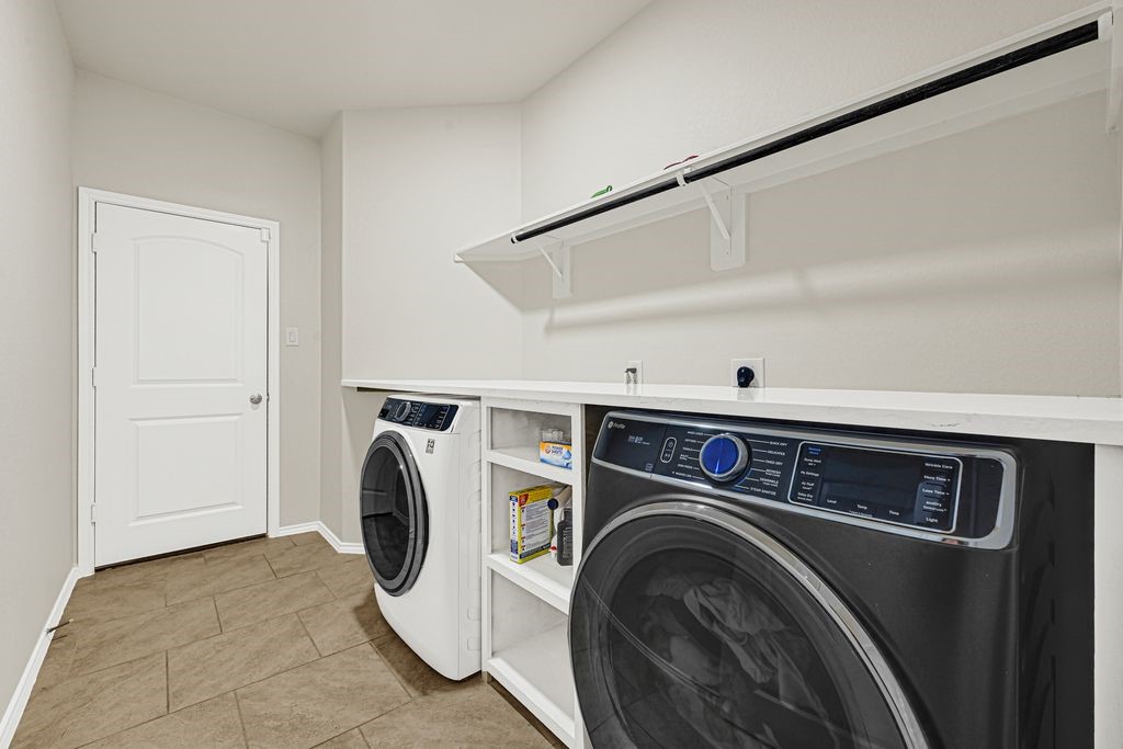 4535 Mondial Road Katy, TX 77493 - Photo 24 of 26 Large laundry room with custom cabinets and large countertop for laundry.