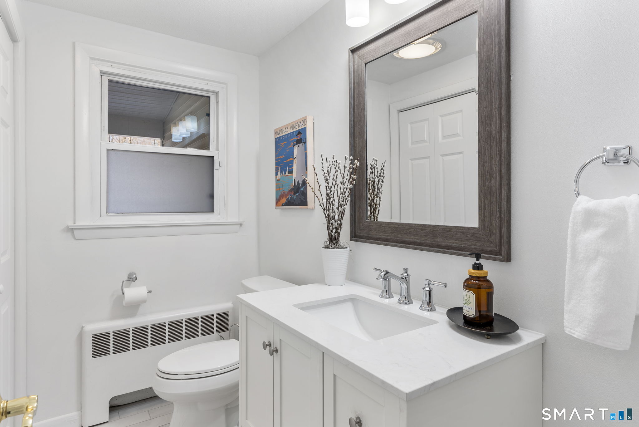 24 Ichabod Road Simsbury, CT 06070 - Photo 12 of 43 a bathroom with a toilet sink and mirror