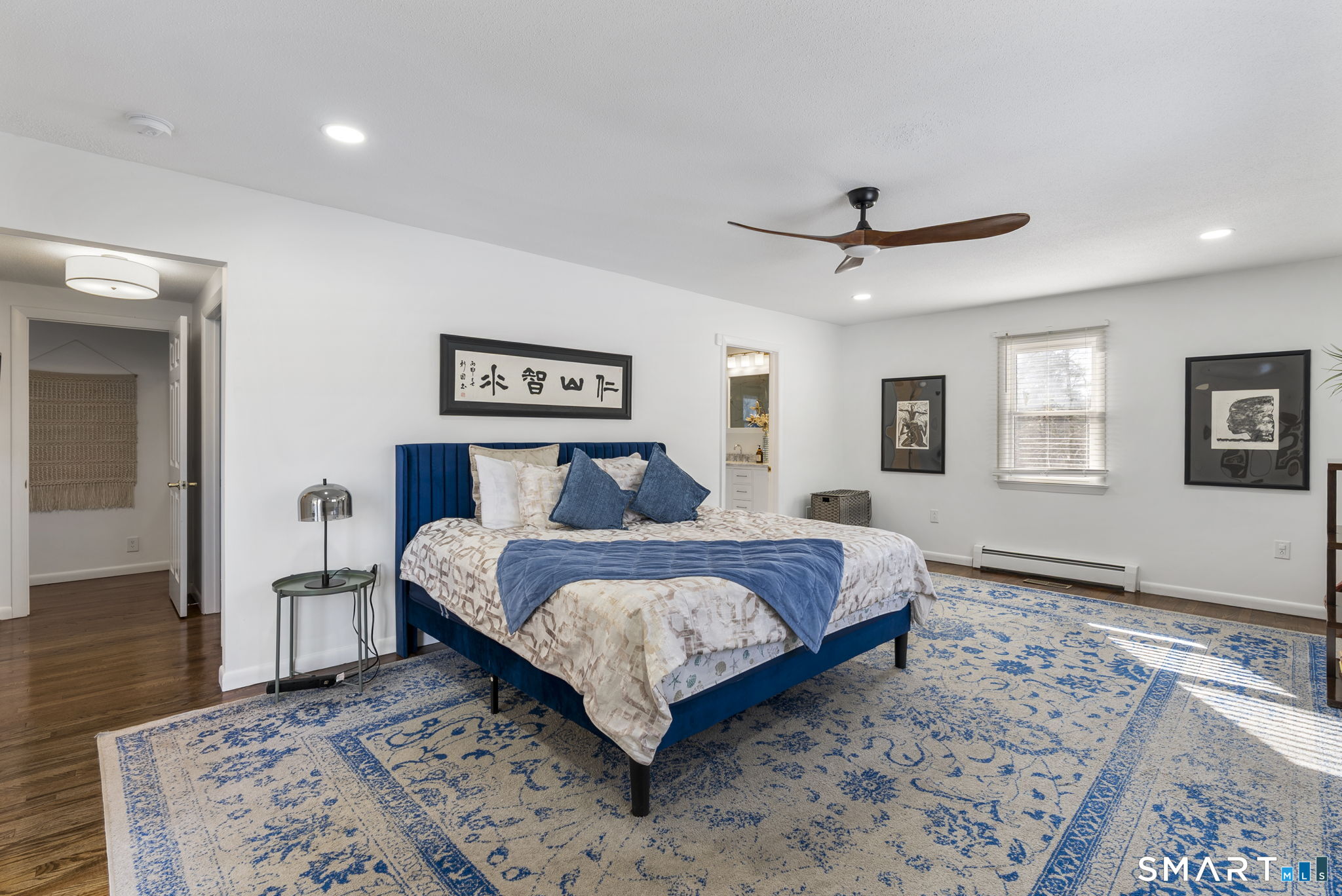 24 Ichabod Road Simsbury, CT 06070 - Photo 15 of 43 a bedroom with a large bed and a chandelier