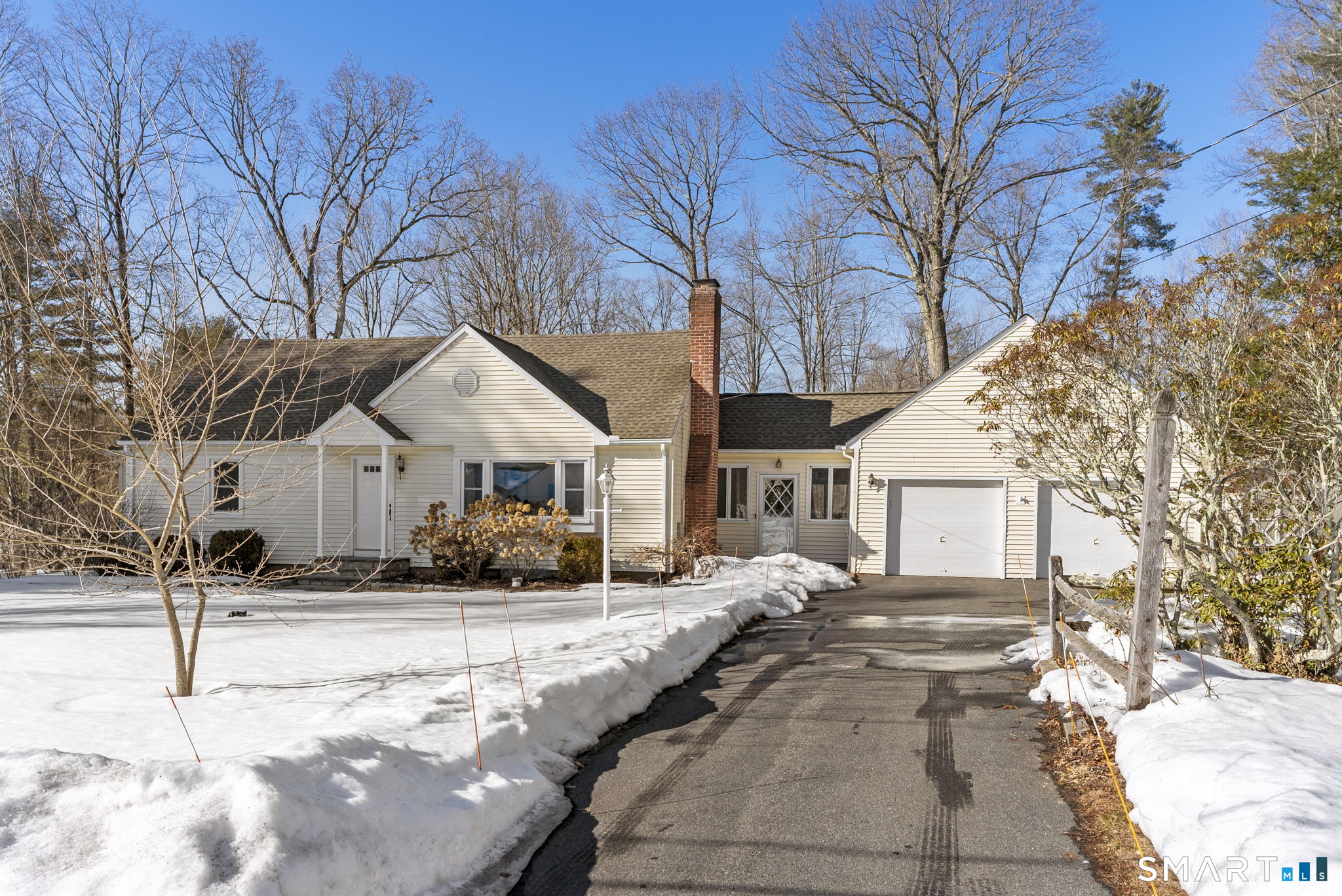 24 Ichabod Road Simsbury, CT 06070 - Photo 2 of 43 a view of a white house with a yard covered in snow