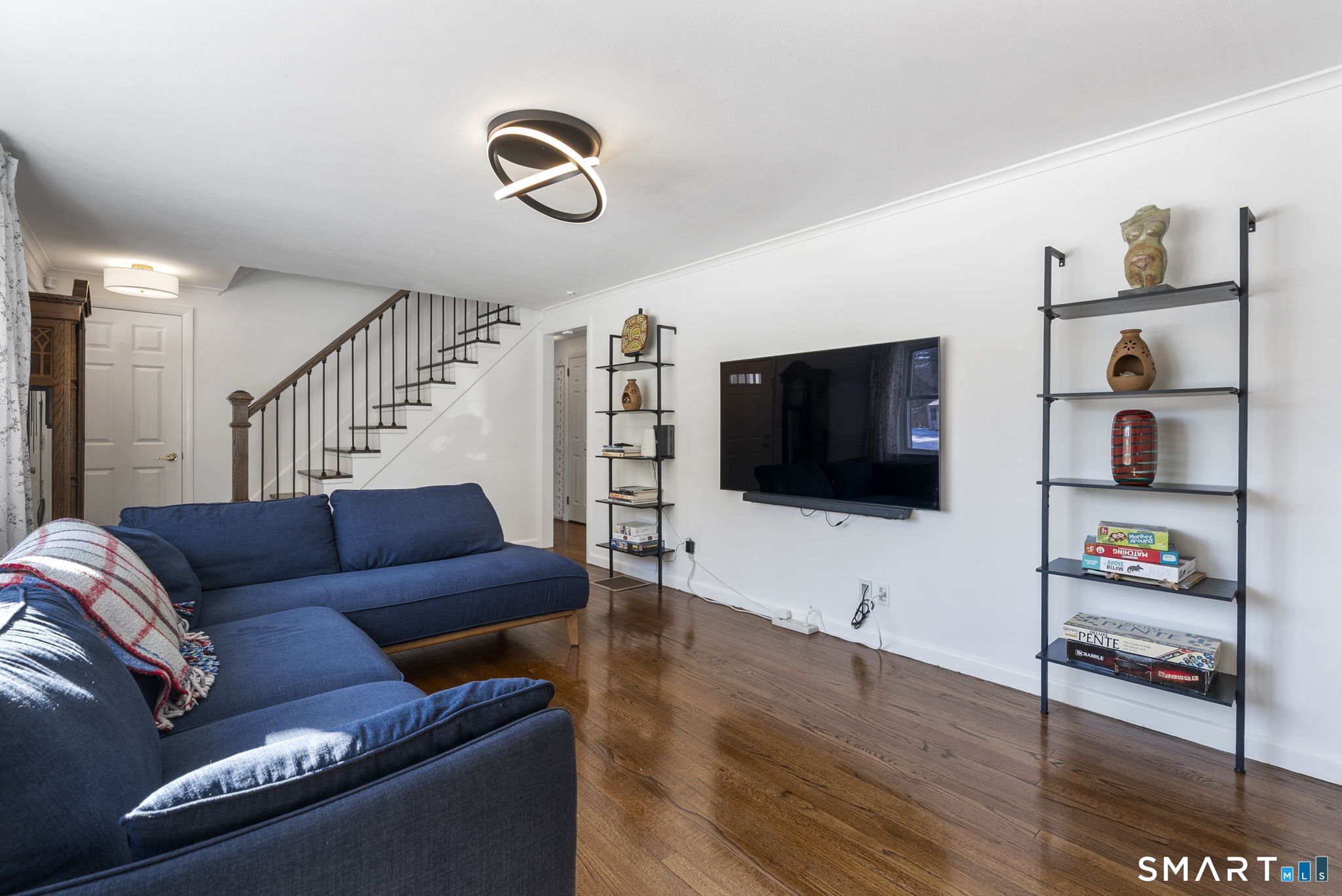 24 Ichabod Road Simsbury, CT 06070 - Photo 22 of 43 a living room with furniture and a flat screen tv