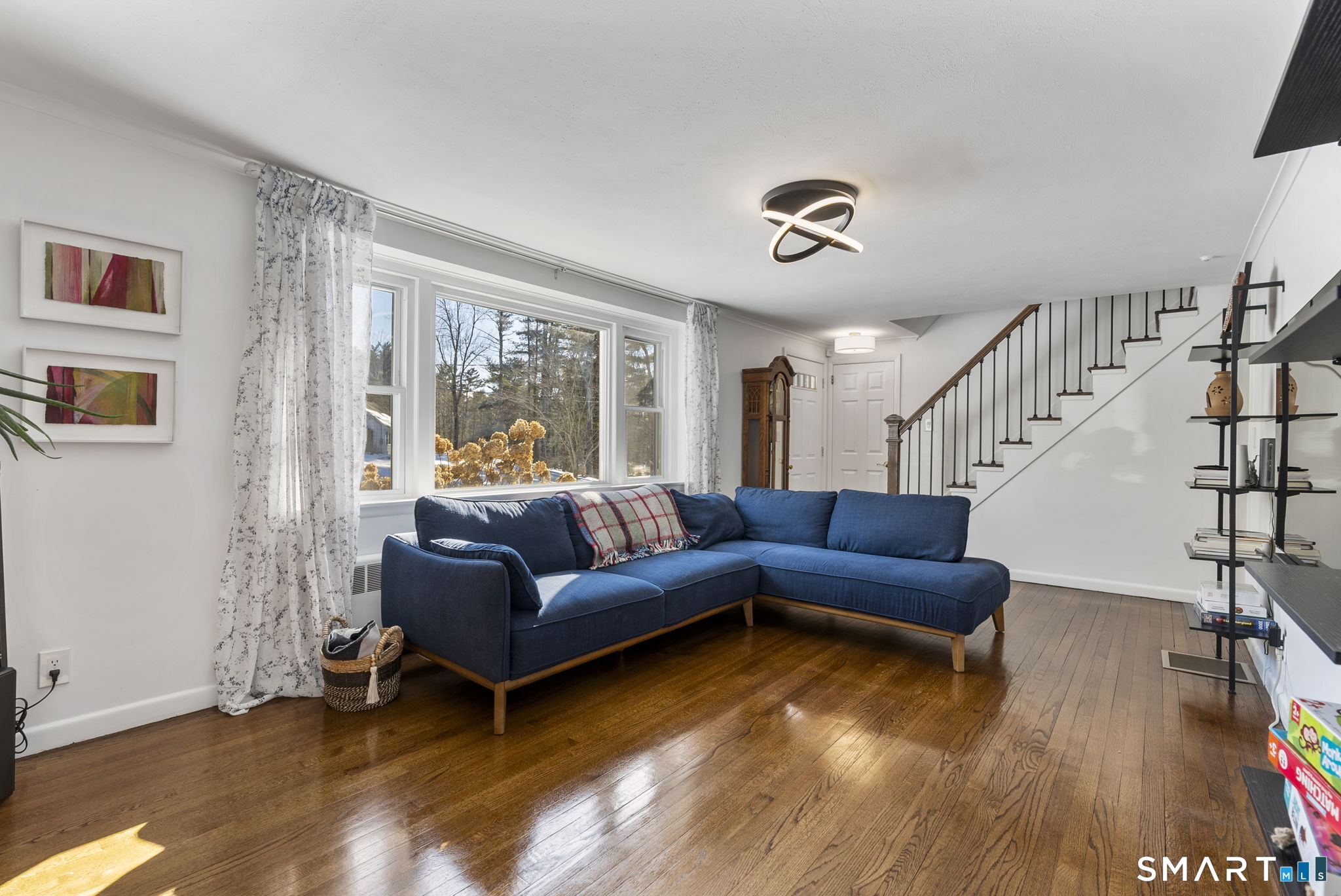 24 Ichabod Road Simsbury, CT 06070 - Photo 23 of 43 a living room with furniture and a wooden floor