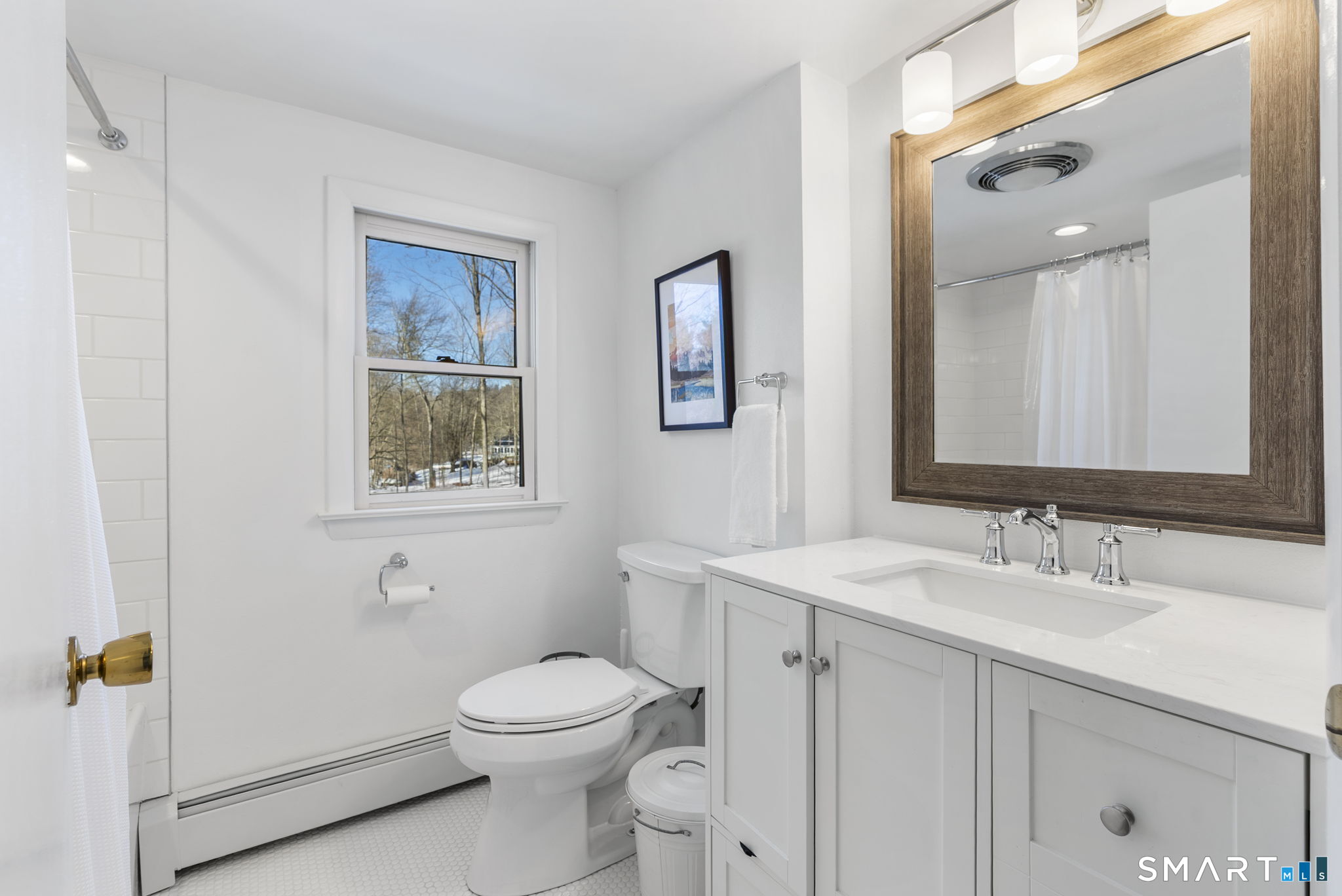 24 Ichabod Road Simsbury, CT 06070 - Photo 27 of 43 a bathroom with a toilet a sink a mirror a vanity and window