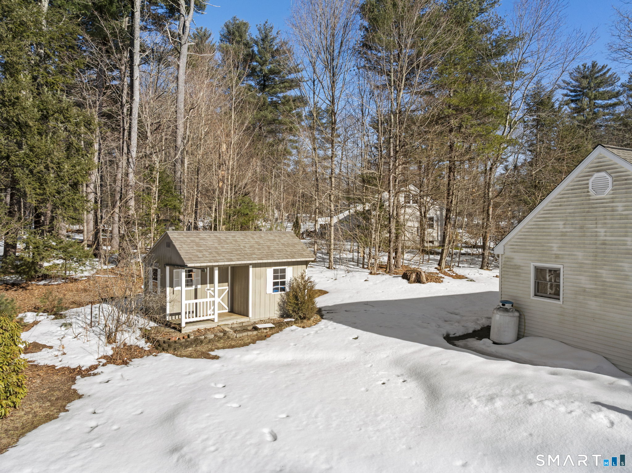 24 Ichabod Road Simsbury, CT 06070 - Photo 37 of 43 a view of a white house with a yard covered in snow