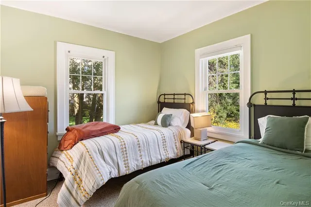 a bedroom with two beds and a window