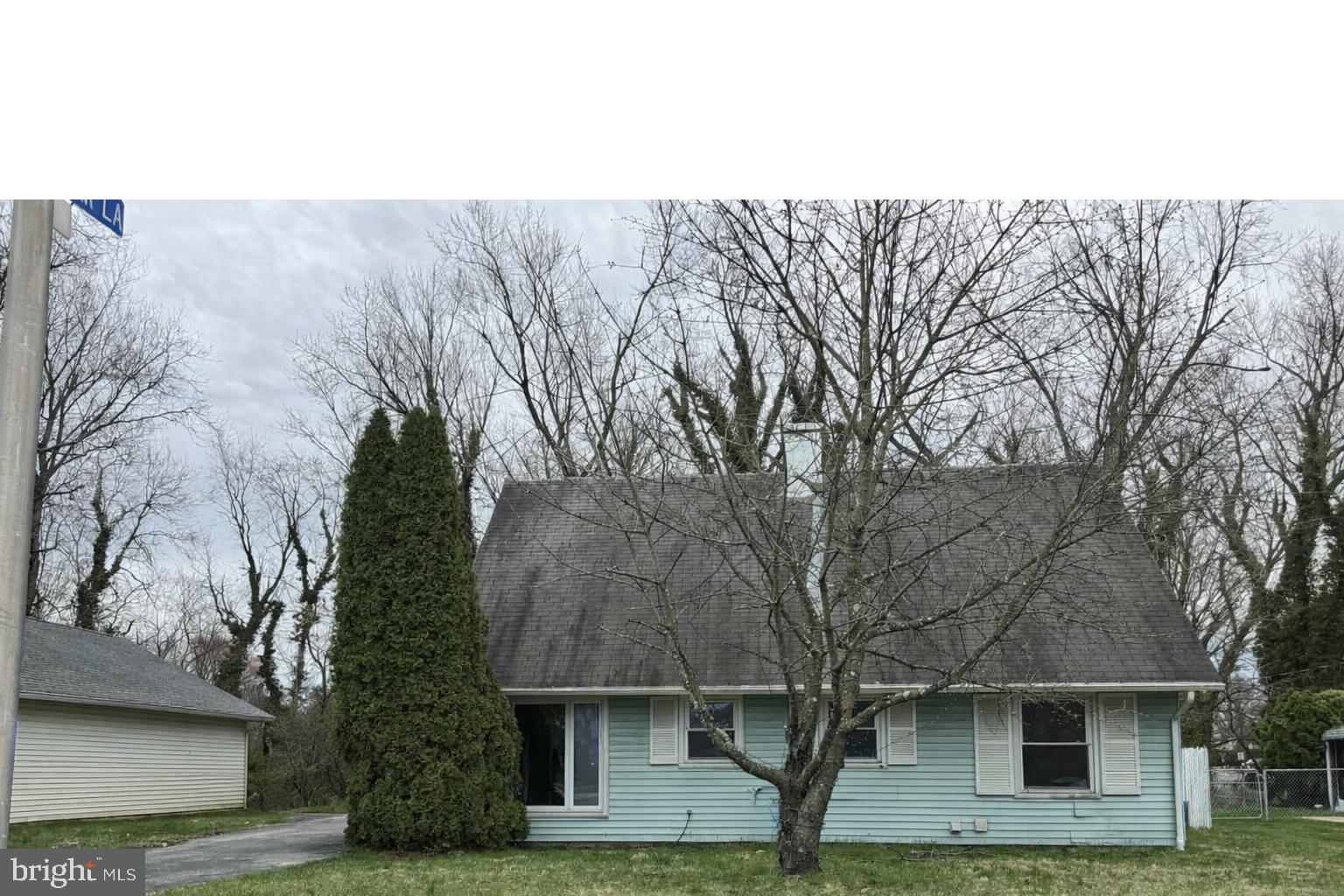 a front view of a house with trees
