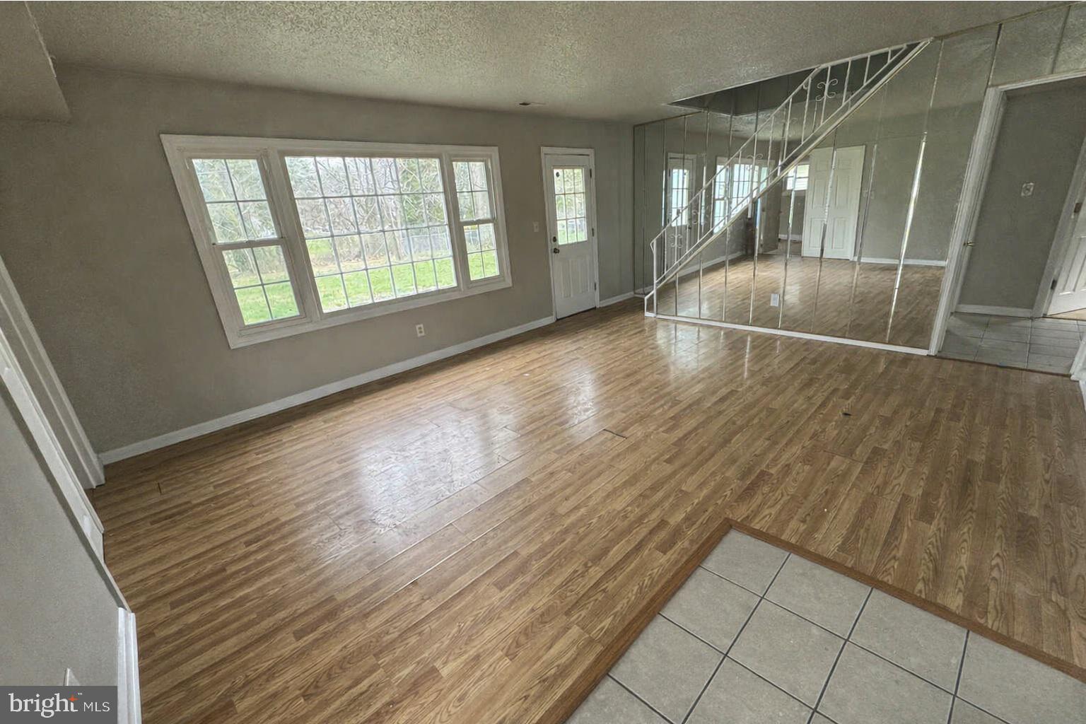 75 Mainbridge Lane Willingboro, NJ 08046 - Photo 2 of 8 an empty room with wooden floor and windows