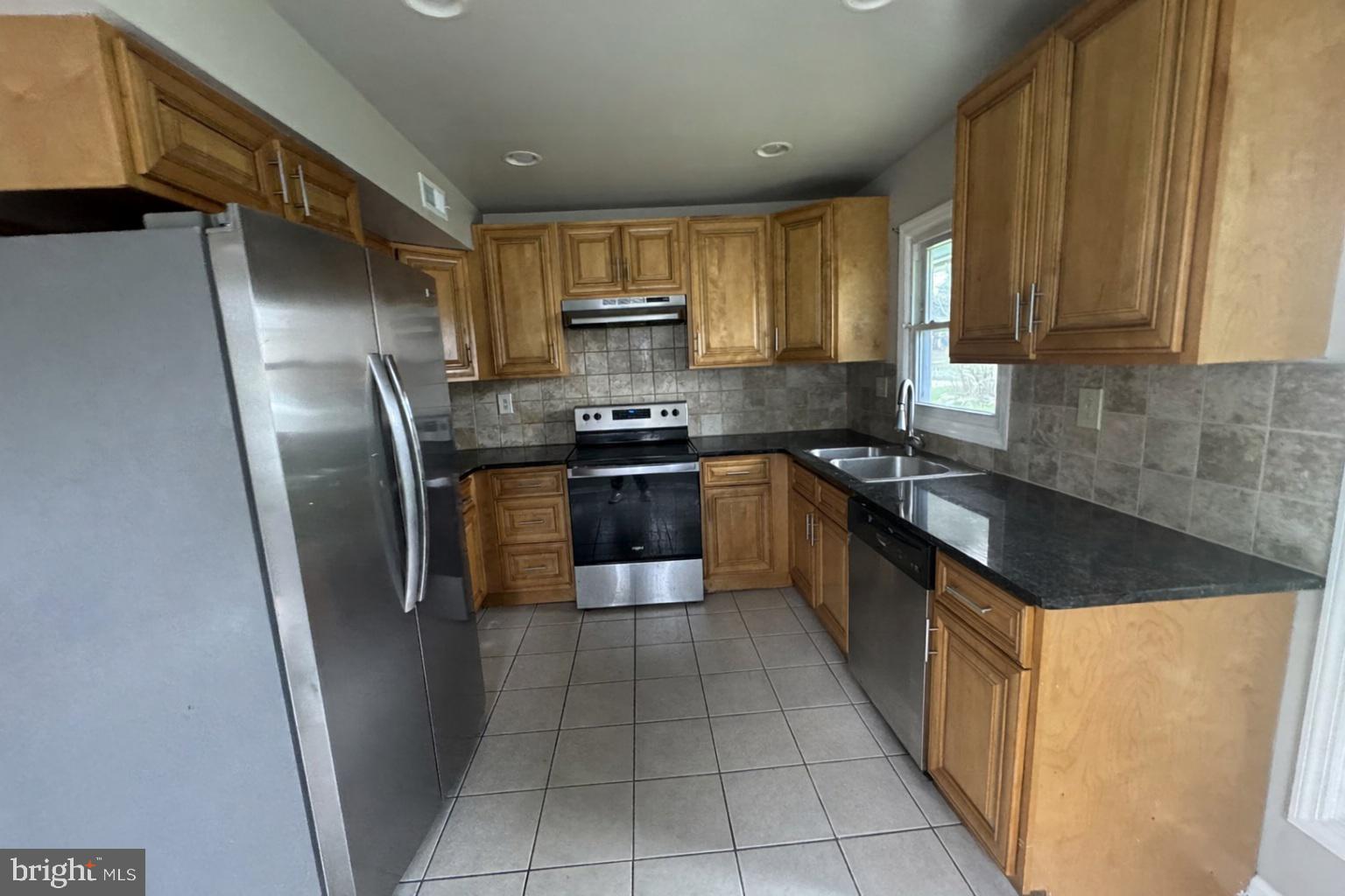 75 Mainbridge Lane Willingboro, NJ 08046 - Photo 4 of 8 a large kitchen with stainless steel appliances granite countertop a refrigerator a sink a stove top oven and a dishwasher