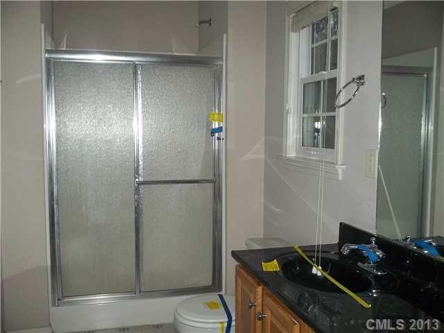 155 Kimball Road China Grove, NC 28023 - Photo 5 of 8 a bathroom with a granite countertop sink toilet and shower