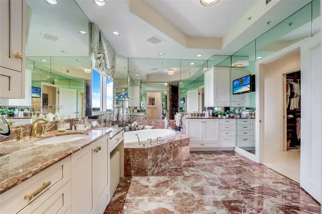 a large kitchen with kitchen island a sink and a counter top space