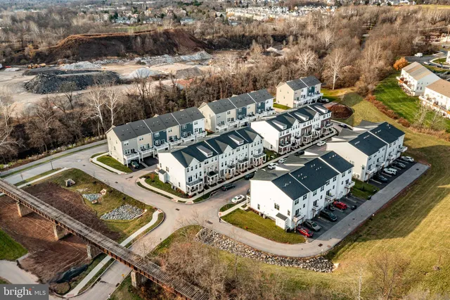 an aerial view of a house with a swimming pool and outdoor seating
