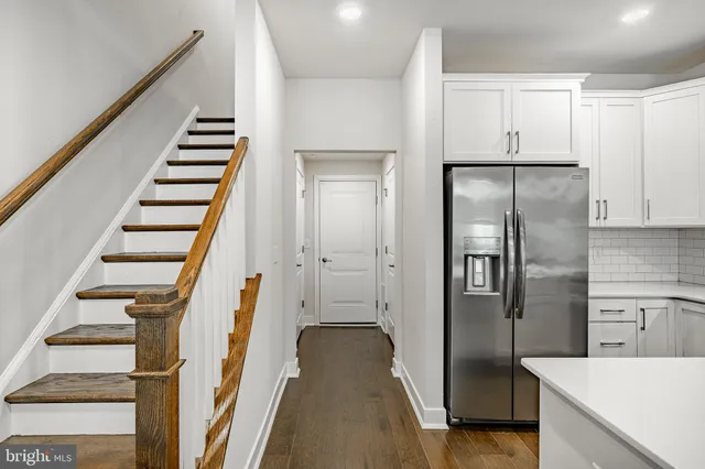 a view of a kitchen with wooden floor and electronic appliances