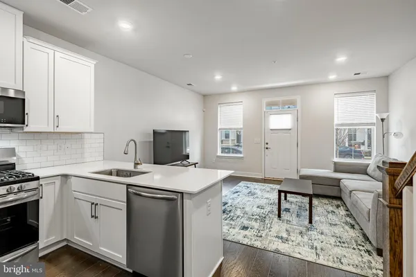 a view of kitchen with sink microwave and stove