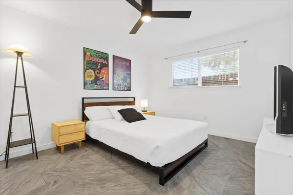 a bedroom with a bed and a flat screen tv