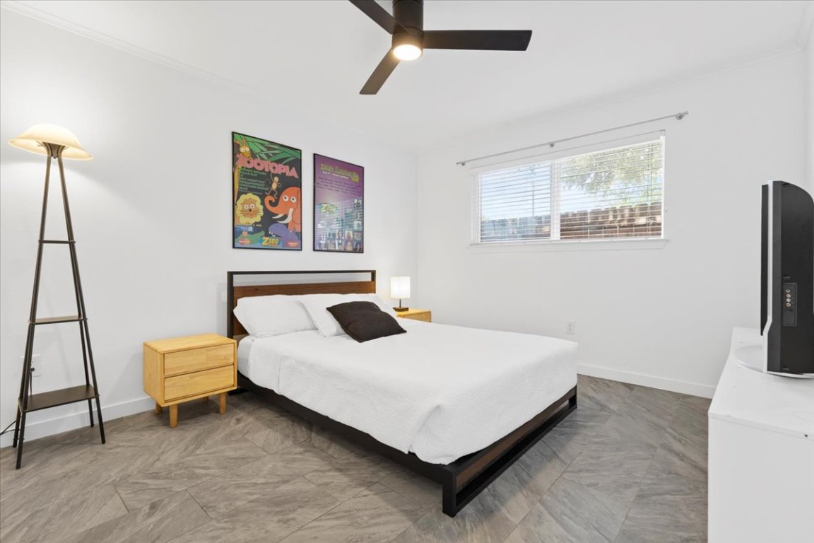 1422 Collier Street, Unit 103 Austin, TX 78704 - Photo 12 of 27 a bedroom with a bed and a flat screen tv