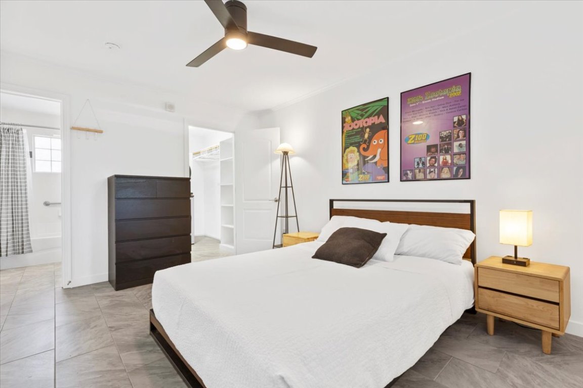 1422 Collier Street, Unit 103 Austin, TX 78704 - Photo 13 of 27 a bedroom with a bed and wooden floor