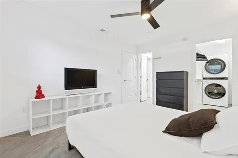 a bedroom with a bed and a flat screen tv