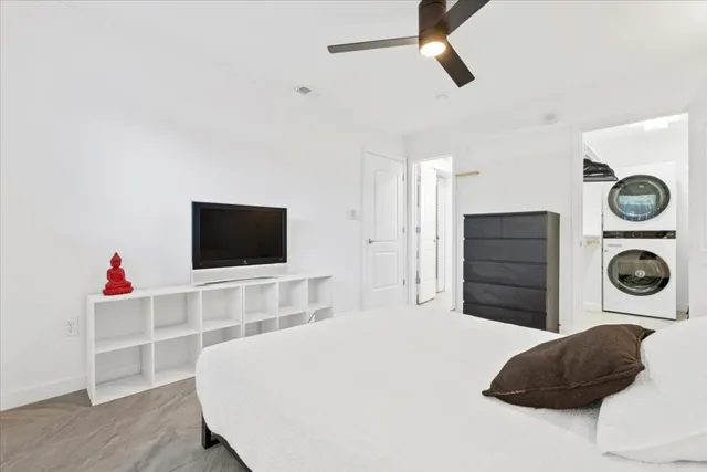 a bedroom with a bed and a flat screen tv