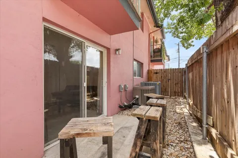 a backyard of a house with table and chairs