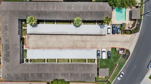 an aerial view of a house with a yard and sitting area