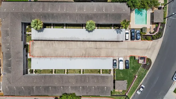 an aerial view of a house with a yard and sitting area