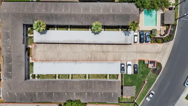 an aerial view of a house with a yard and sitting area