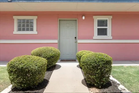 a view of a two chairs in a patio of the house