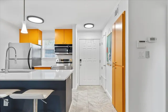 a kitchen with a sink cabinets and a refrigerator