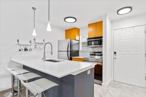 a kitchen with a sink cabinets and appliances