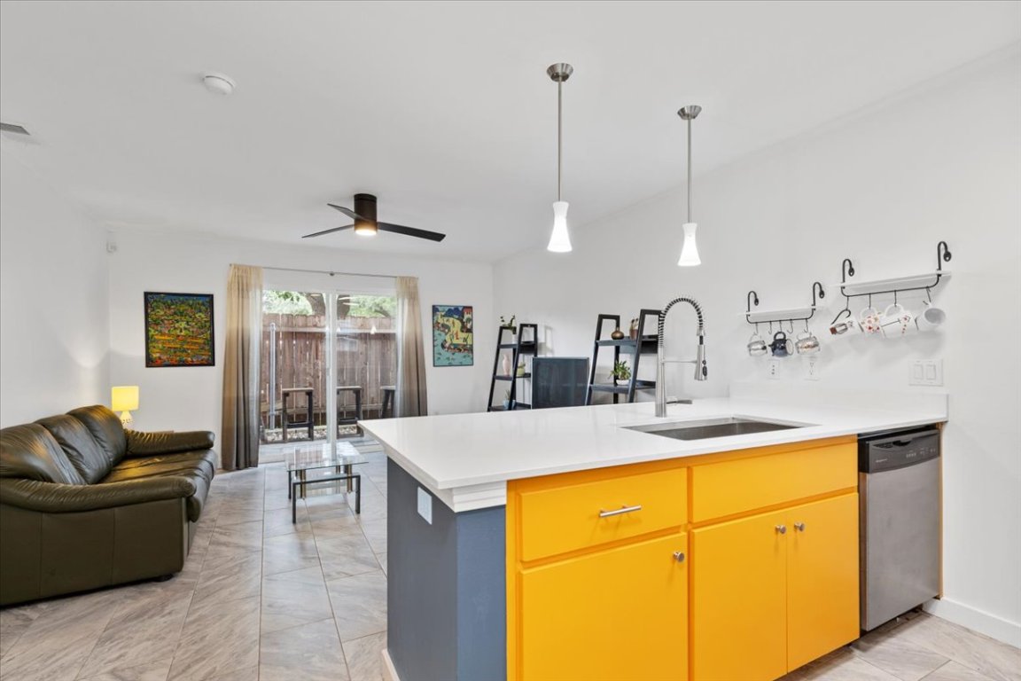 1422 Collier Street, Unit 103 Austin, TX 78704 - Photo 26 of 27 a living room with stainless steel appliances kitchen island granite countertop furniture and a sink