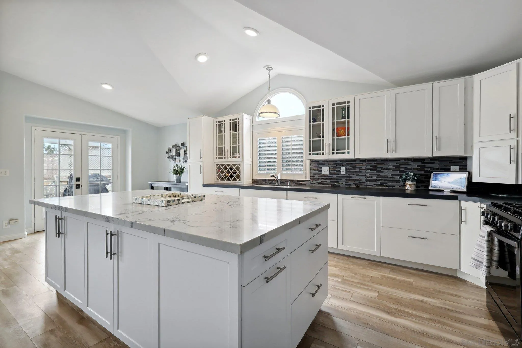 7002 San Bartolo Street, Unit 30 Carlsbad, CA 92011 - Photo 13 of 59 a kitchen with granite countertop a sink white cabinets and white appliances