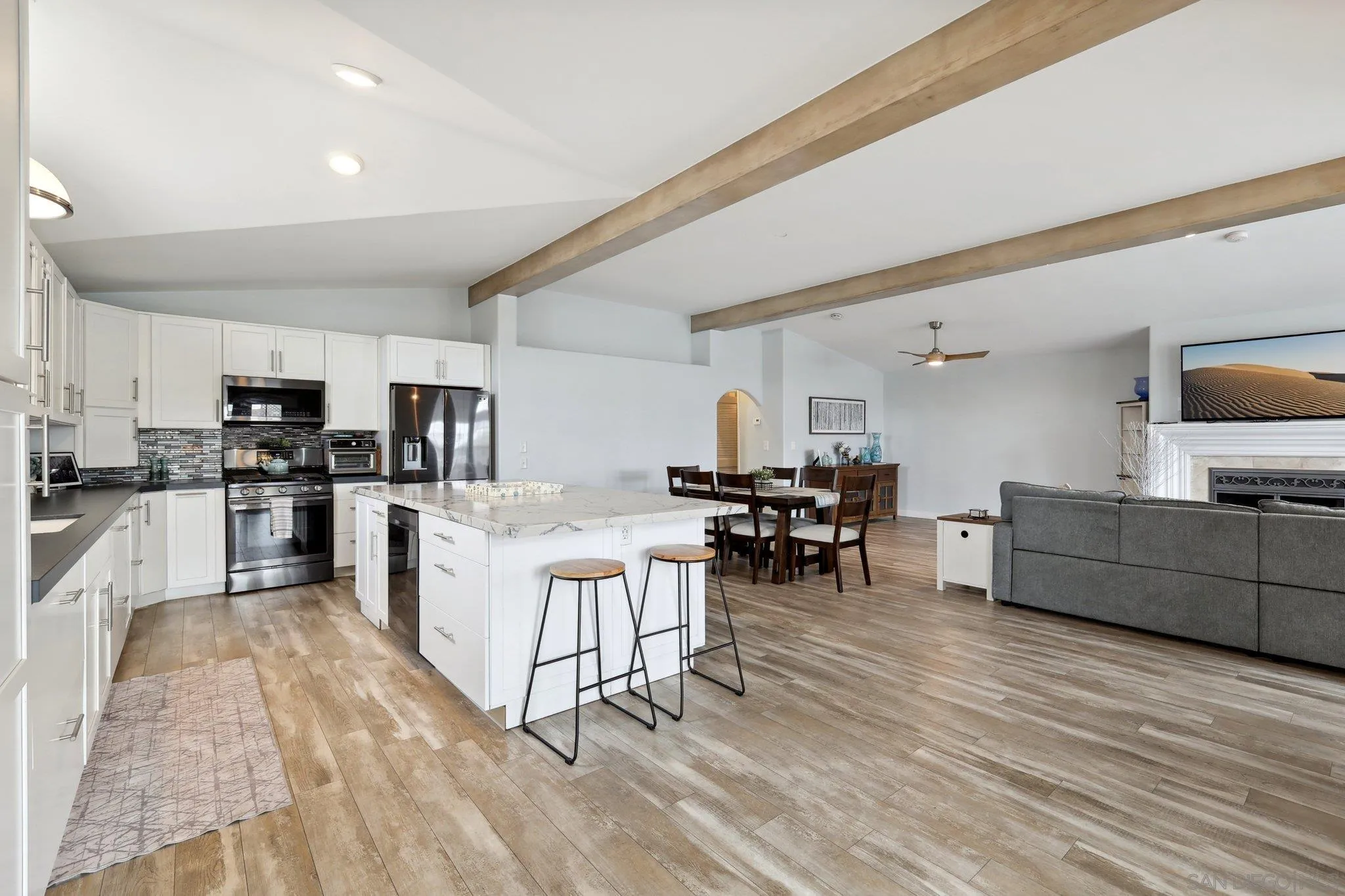 7002 San Bartolo Street, Unit 30 Carlsbad, CA 92011 - Photo 15 of 59 a large white kitchen with lots of counter space and stainless steel appliances