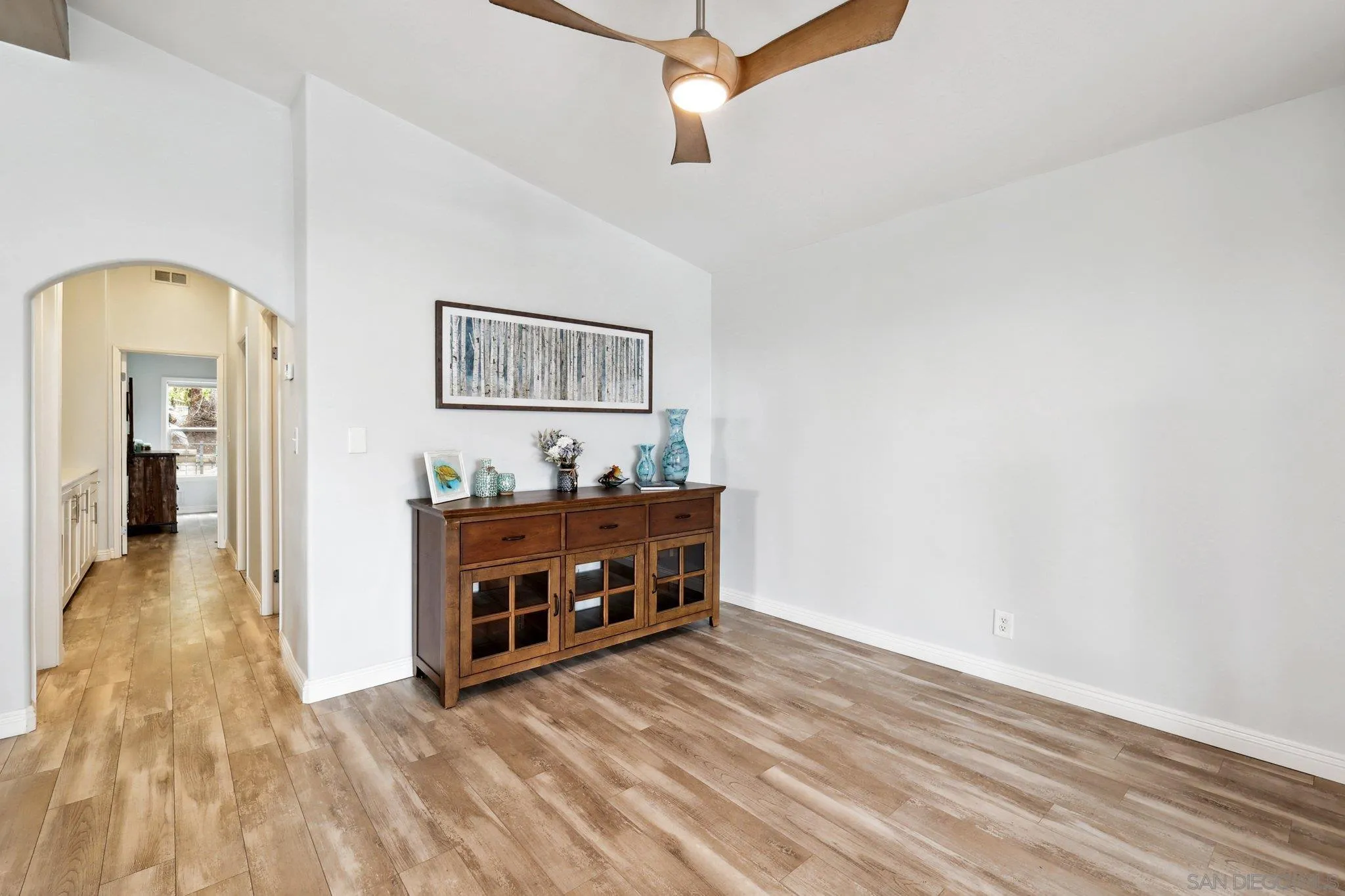 7002 San Bartolo Street, Unit 30 Carlsbad, CA 92011 - Photo 16 of 59 a view of a hallway with wooden floor and staircase