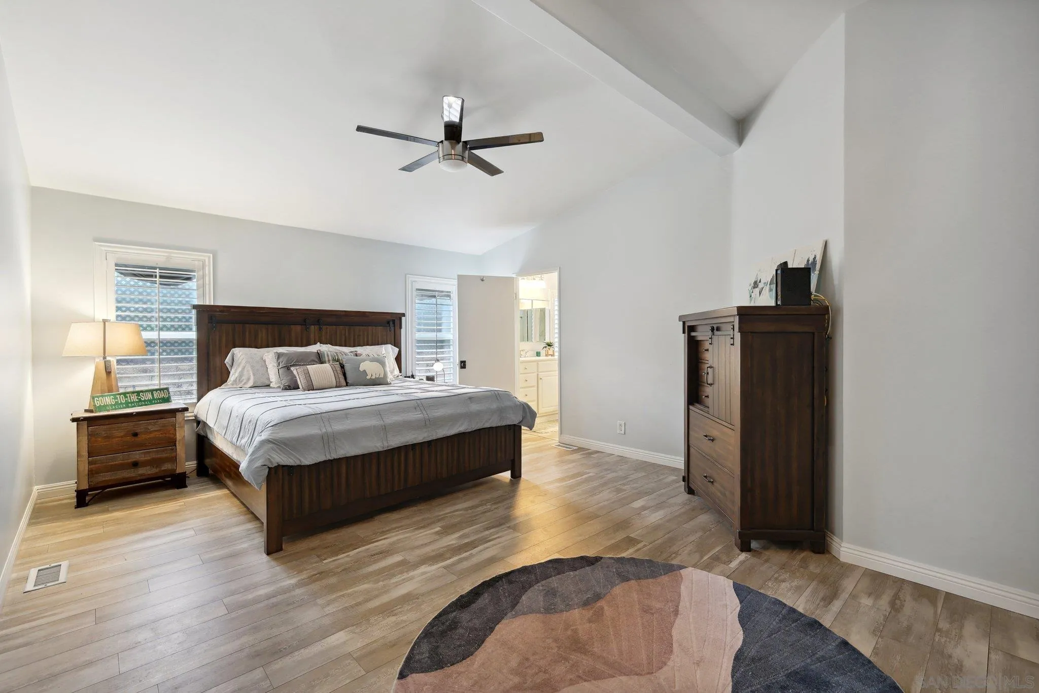 7002 San Bartolo Street, Unit 30 Carlsbad, CA 92011 - Photo 17 of 59 a bedroom with a bed and wooden floor