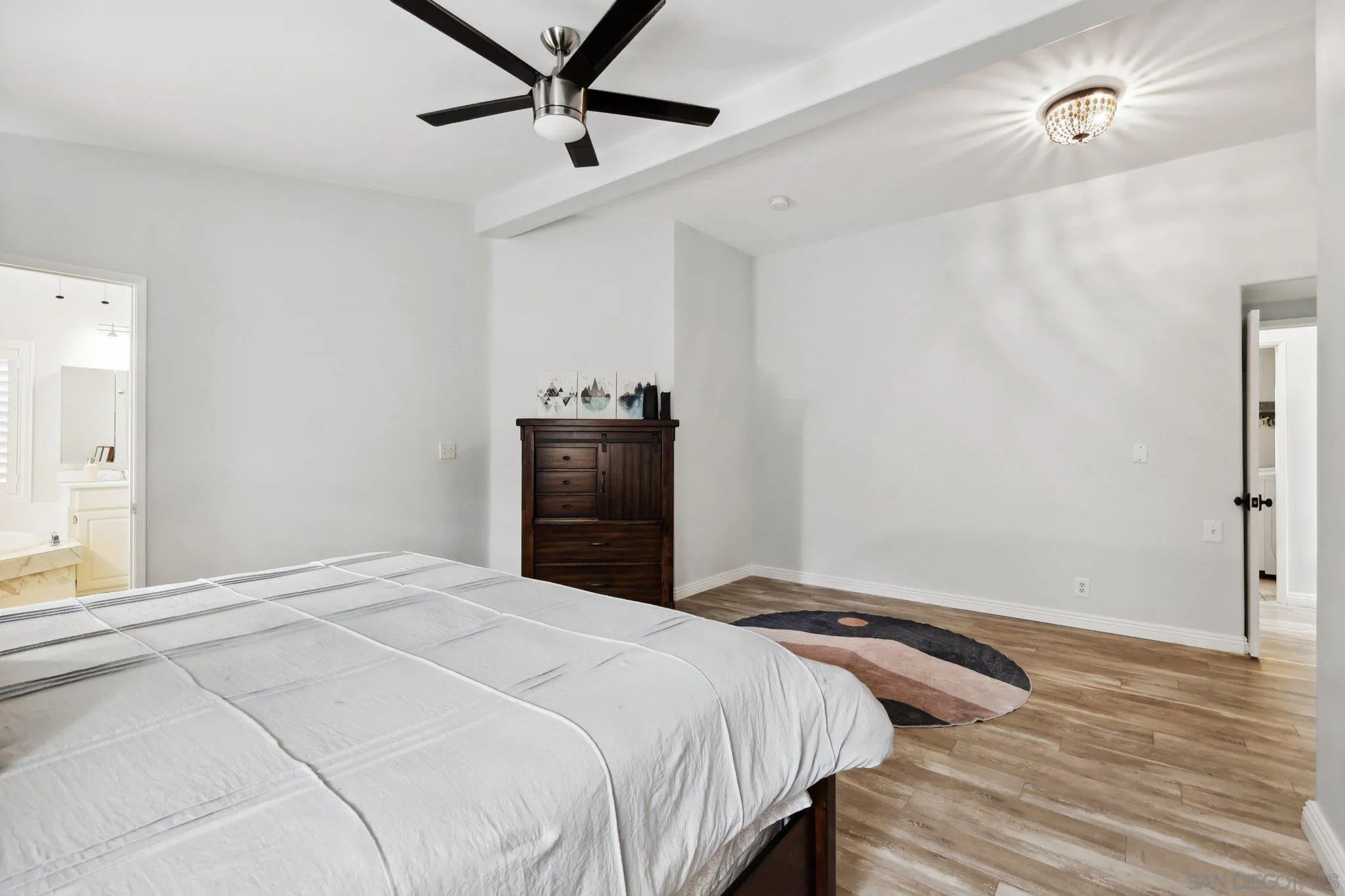 7002 San Bartolo Street, Unit 30 Carlsbad, CA 92011 - Photo 19 of 59 a bedroom with a bed and a dresser