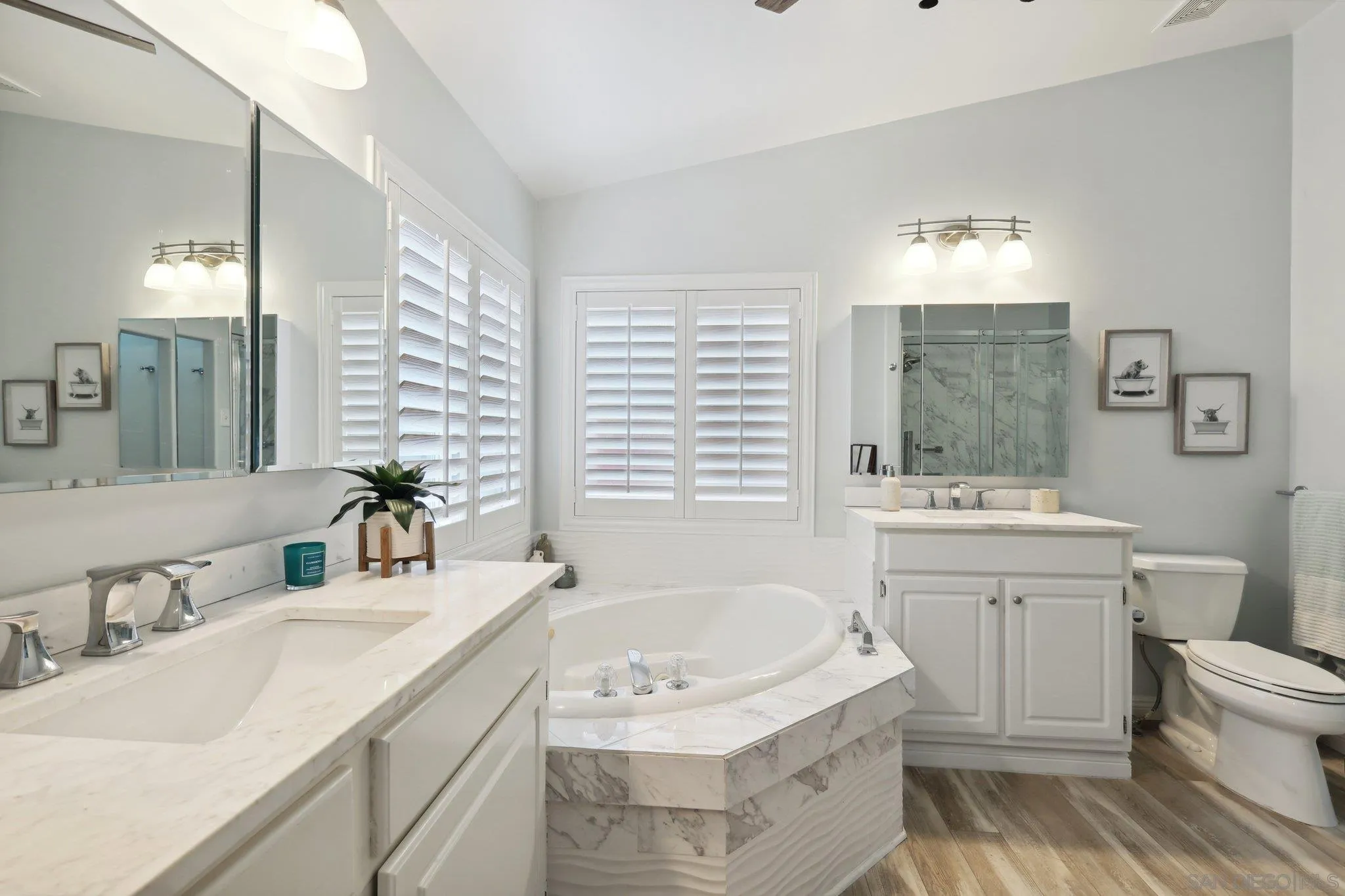 7002 San Bartolo Street, Unit 30 Carlsbad, CA 92011 - Photo 20 of 59 a bathroom with a granite countertop sink a toilet a mirror and bathtub