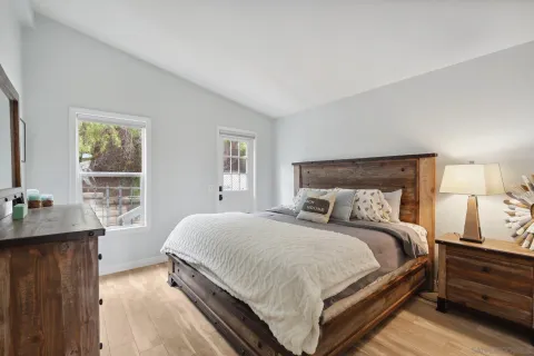 a bedroom with a bed and a flat screen tv