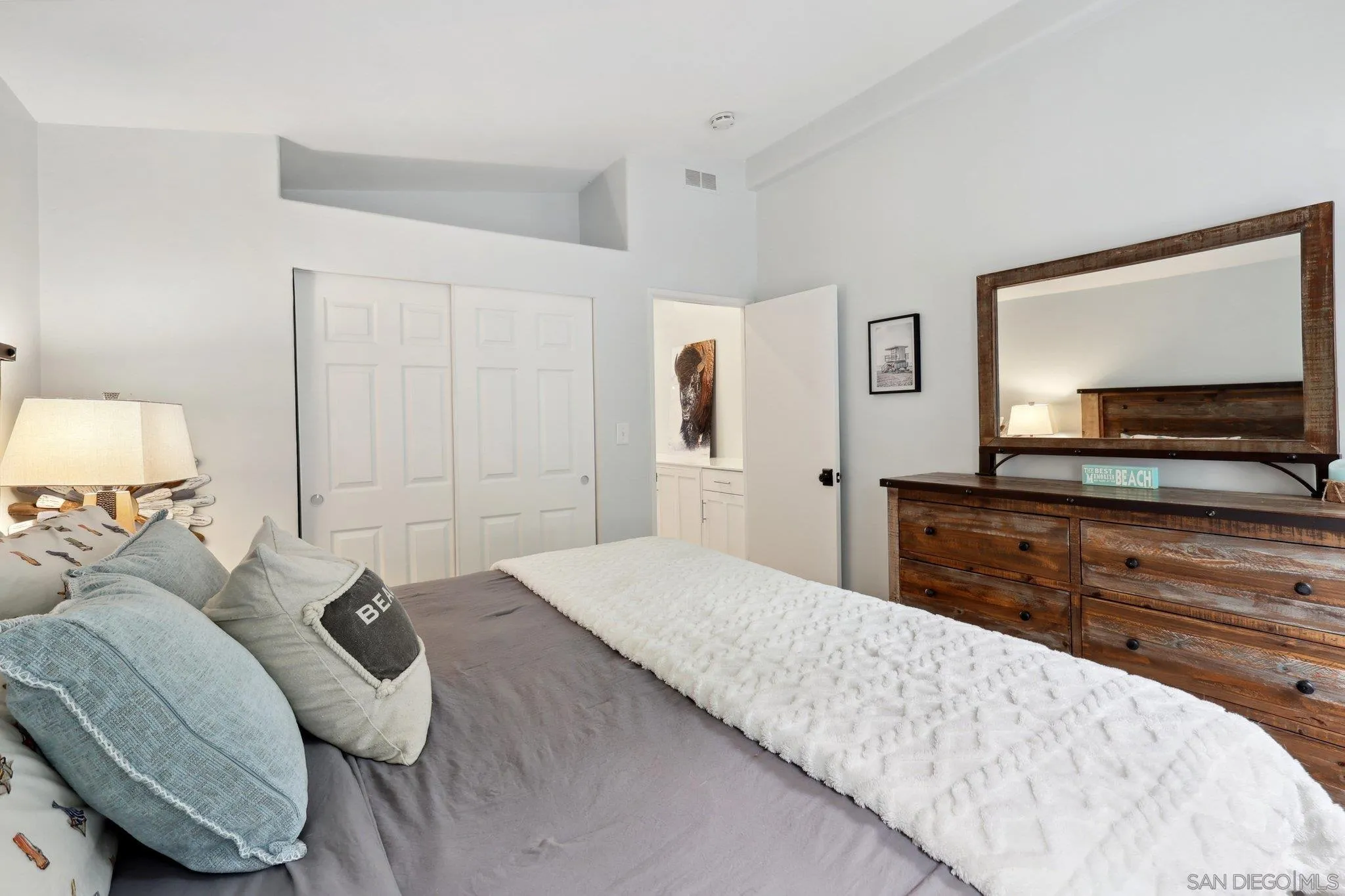 7002 San Bartolo Street, Unit 30 Carlsbad, CA 92011 - Photo 27 of 59 a bedroom with a bed and a flat screen tv