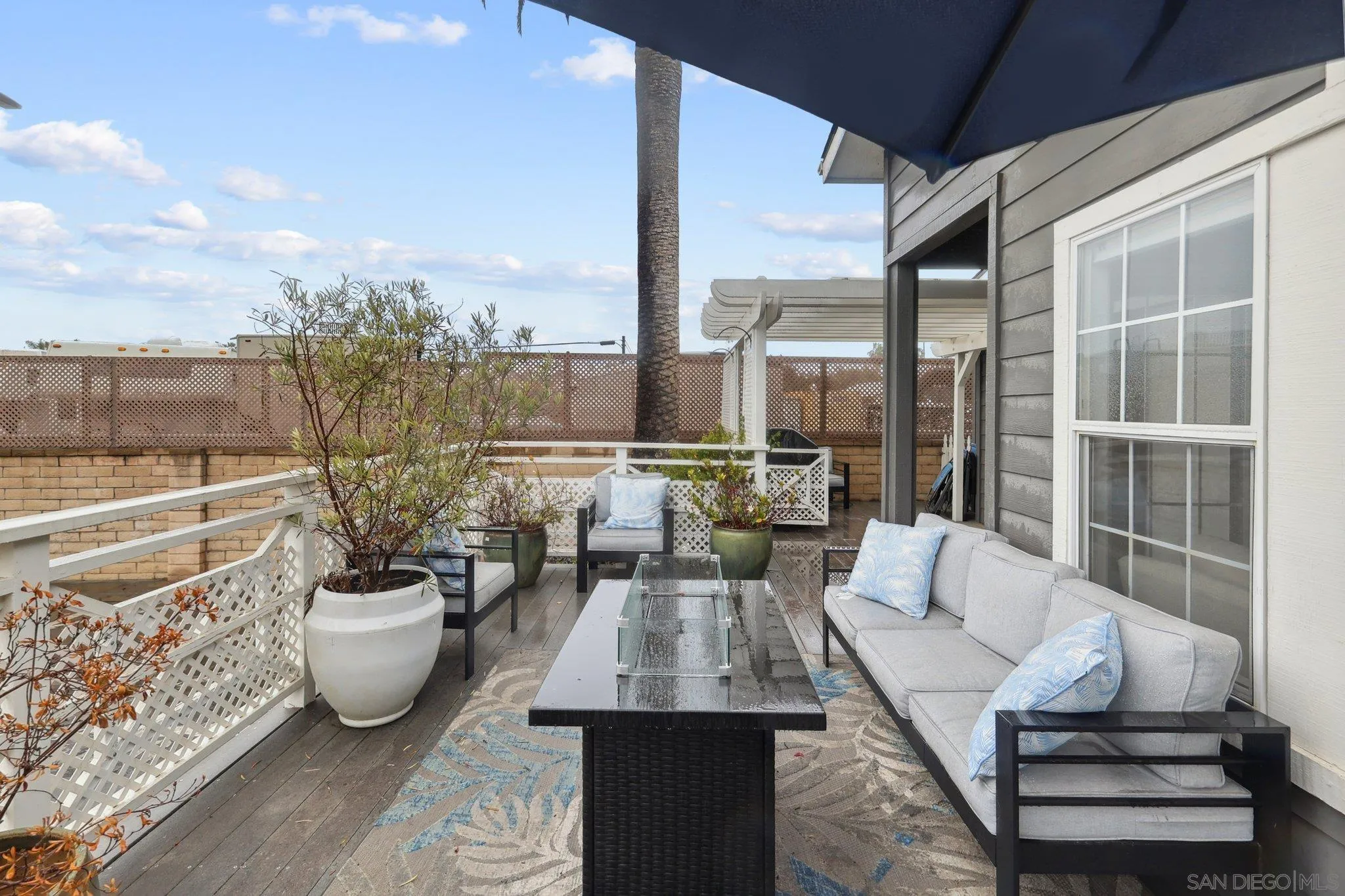 7002 San Bartolo Street, Unit 30 Carlsbad, CA 92011 - Photo 31 of 59 a view of a patio with couches chairs and potted plants