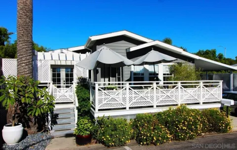 an aerial view of multiple houses with a yard