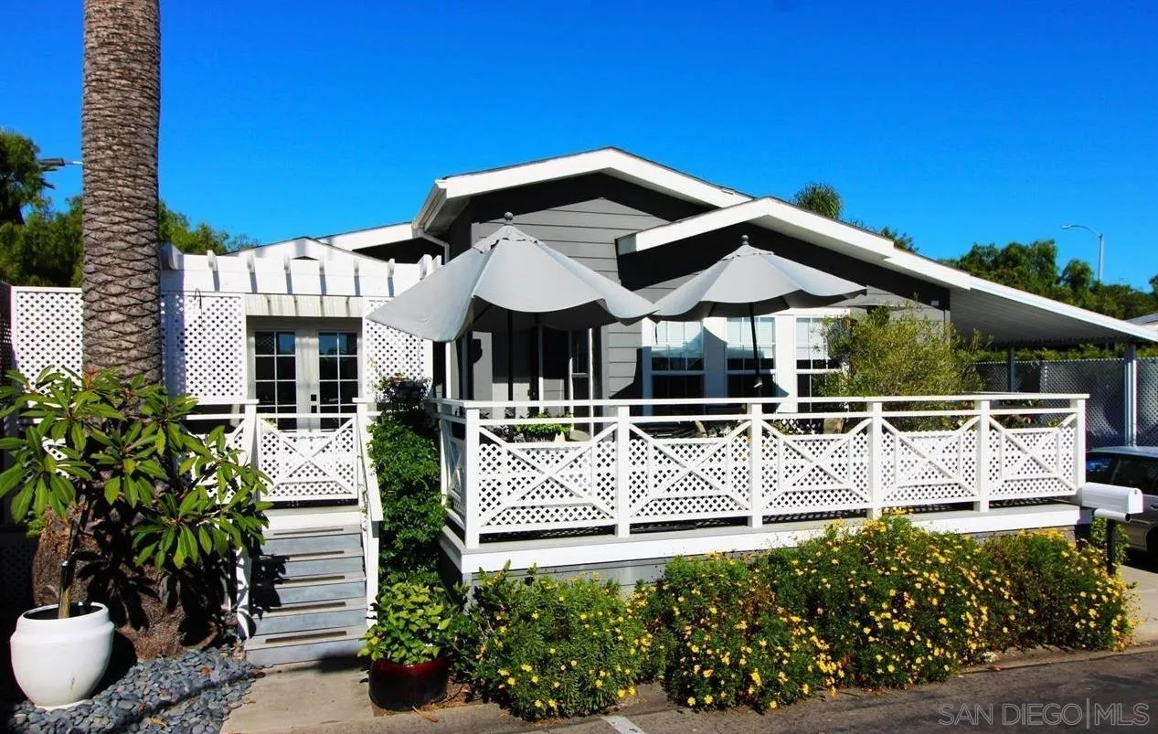7002 San Bartolo Street, Unit 30 Carlsbad, CA 92011 - Photo 34 of 59 a view of a white house with a fountain and potted plants