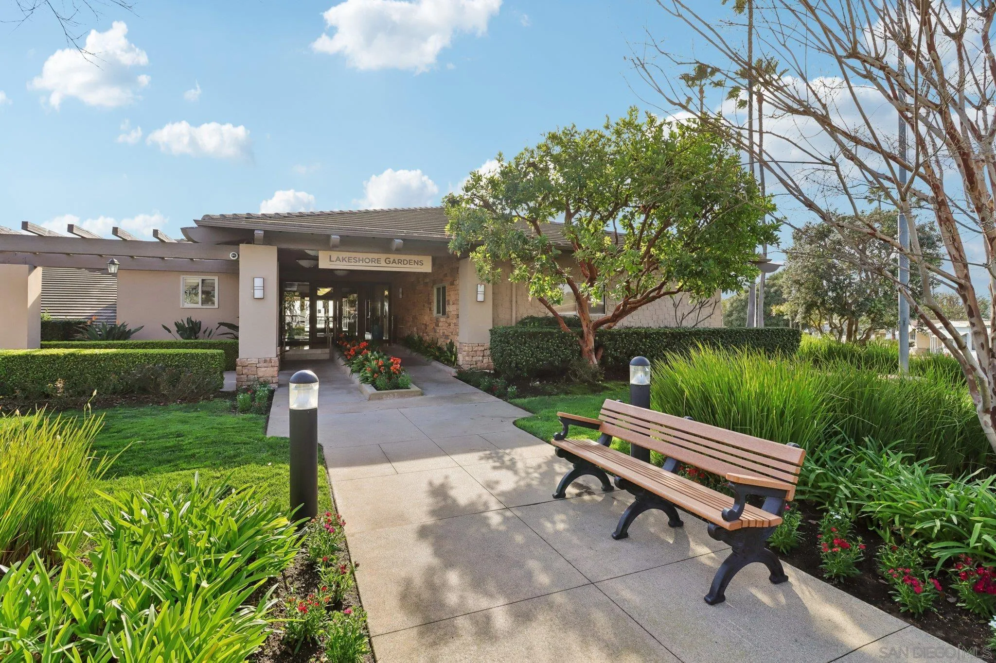 7002 San Bartolo Street, Unit 30 Carlsbad, CA 92011 - Photo 40 of 59 a backyard of a house with a garden and outdoor seating