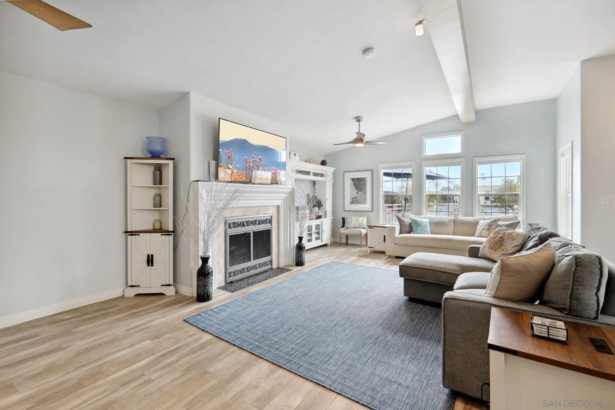 7002 San Bartolo Street, Unit 30 Carlsbad, CA 92011 - Photo 7 of 59 a living room with furniture large window and a fireplace