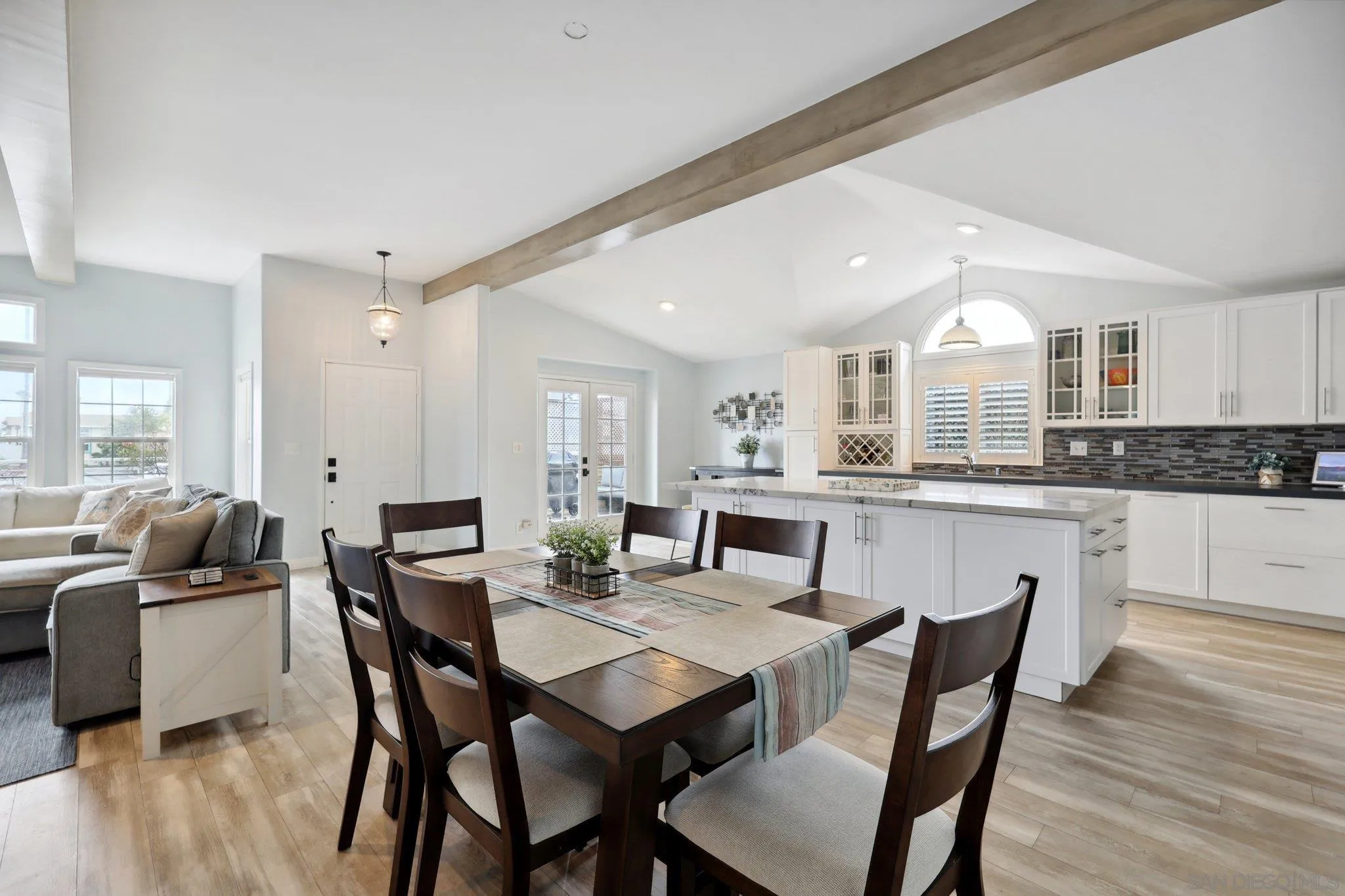 7002 San Bartolo Street, Unit 30 Carlsbad, CA 92011 - Photo 8 of 59 a view of a dining room with furniture and wooden floor