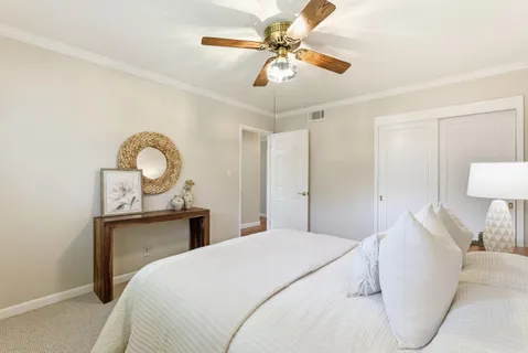 a bedroom with a bed and lamp