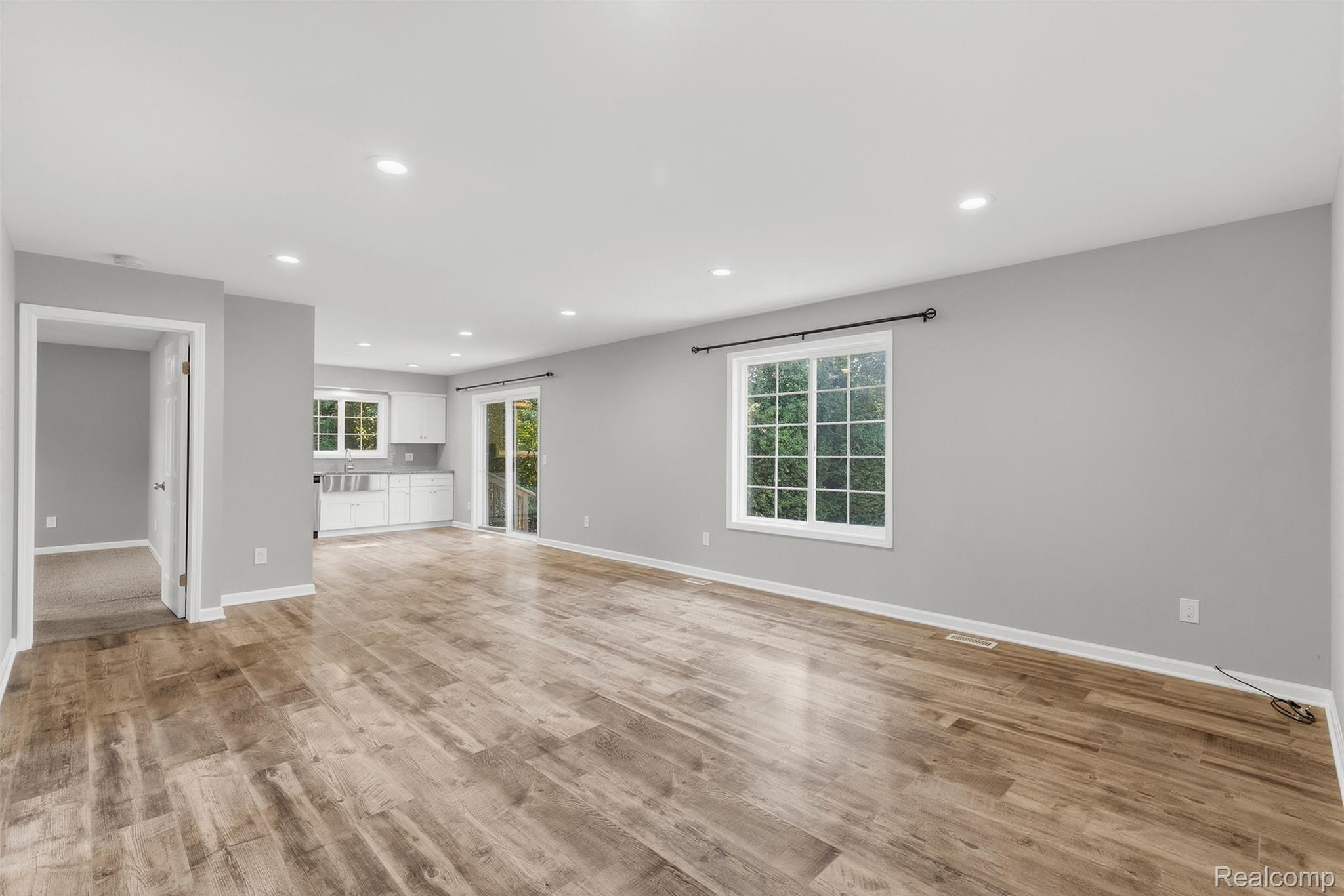 1750 Henbert Road West Bloomfield, MI 48324 - Photo 10 of 32 Spacious open-concept room featuring wood-finish flooring, recessed lighting, and a white grid-pattern window
